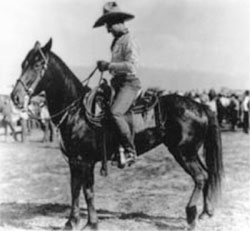 historic photo of man on a horse wearing a hat